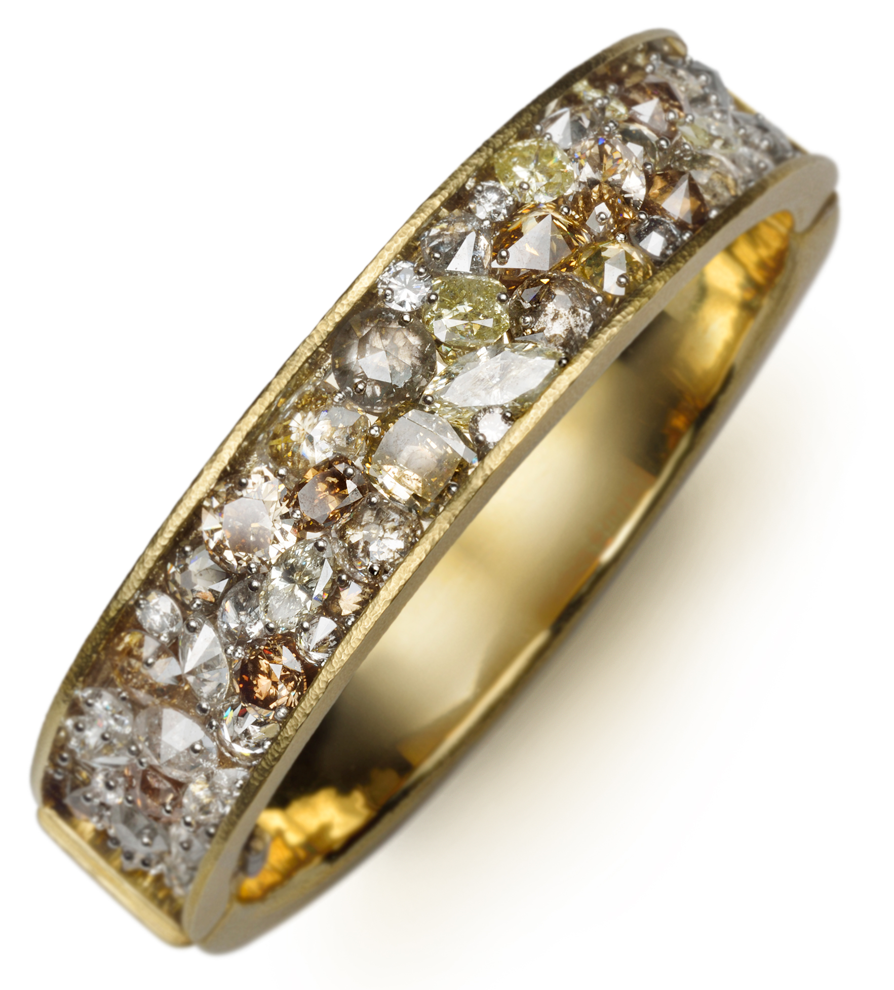 Wide hinged bangle with mixed shaped and colored drilled diamonds set with platinum pins on a layer of 14K white gold wrapped with 18K yellow gold, 